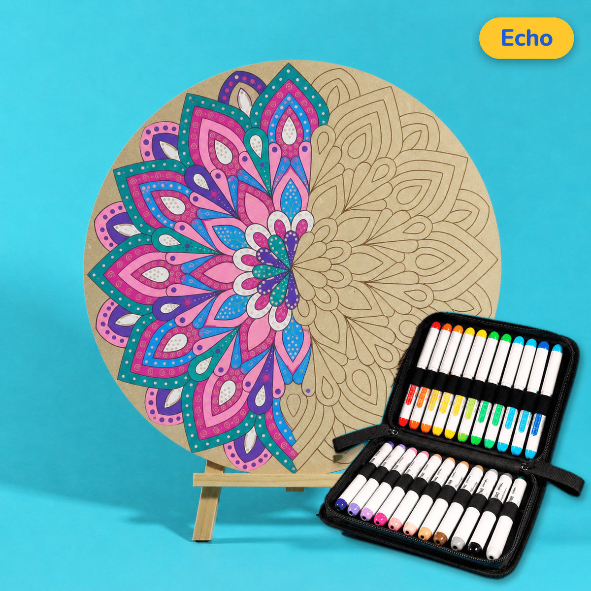 400mm Echo engraved circle art board with mandala of layered pointed petals, left half coloured hot pink, teal and purple, beside a case of 24 Nahuku markers