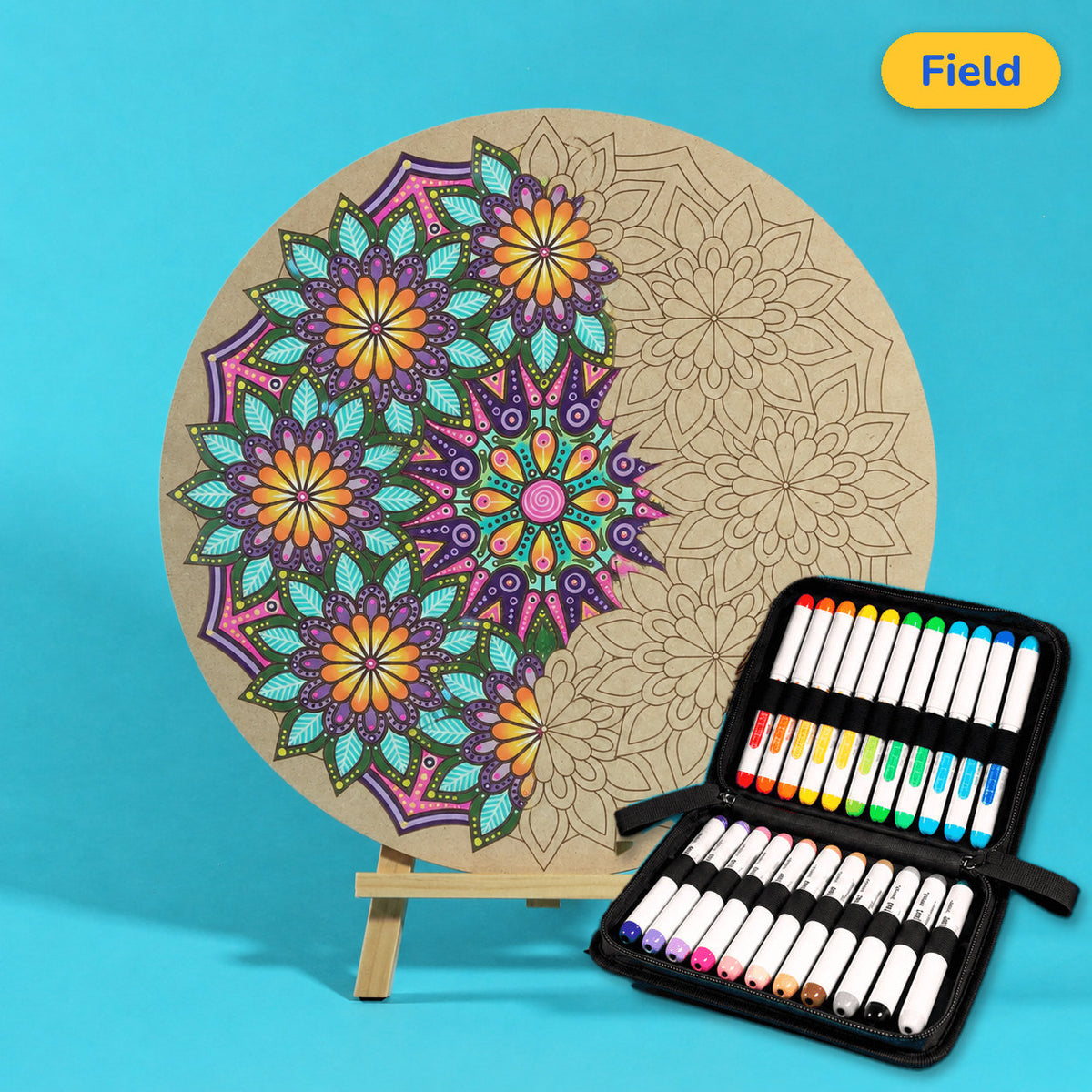 400mm Field engraved circle art board with mandala of repeating flowers, left side coloured purple, teal and yellow, beside a case of 24 Nahuku markers
