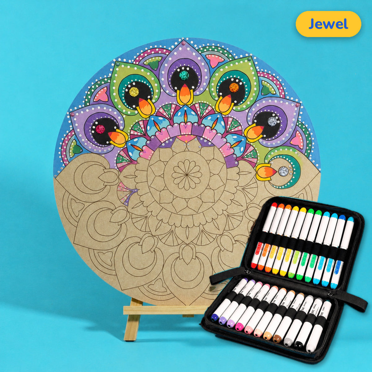 400mm Jewel engraved circle art board with mandala of scalloped rings, top half coloured purple, green and orange, beside a case of 24 Nahuku markers