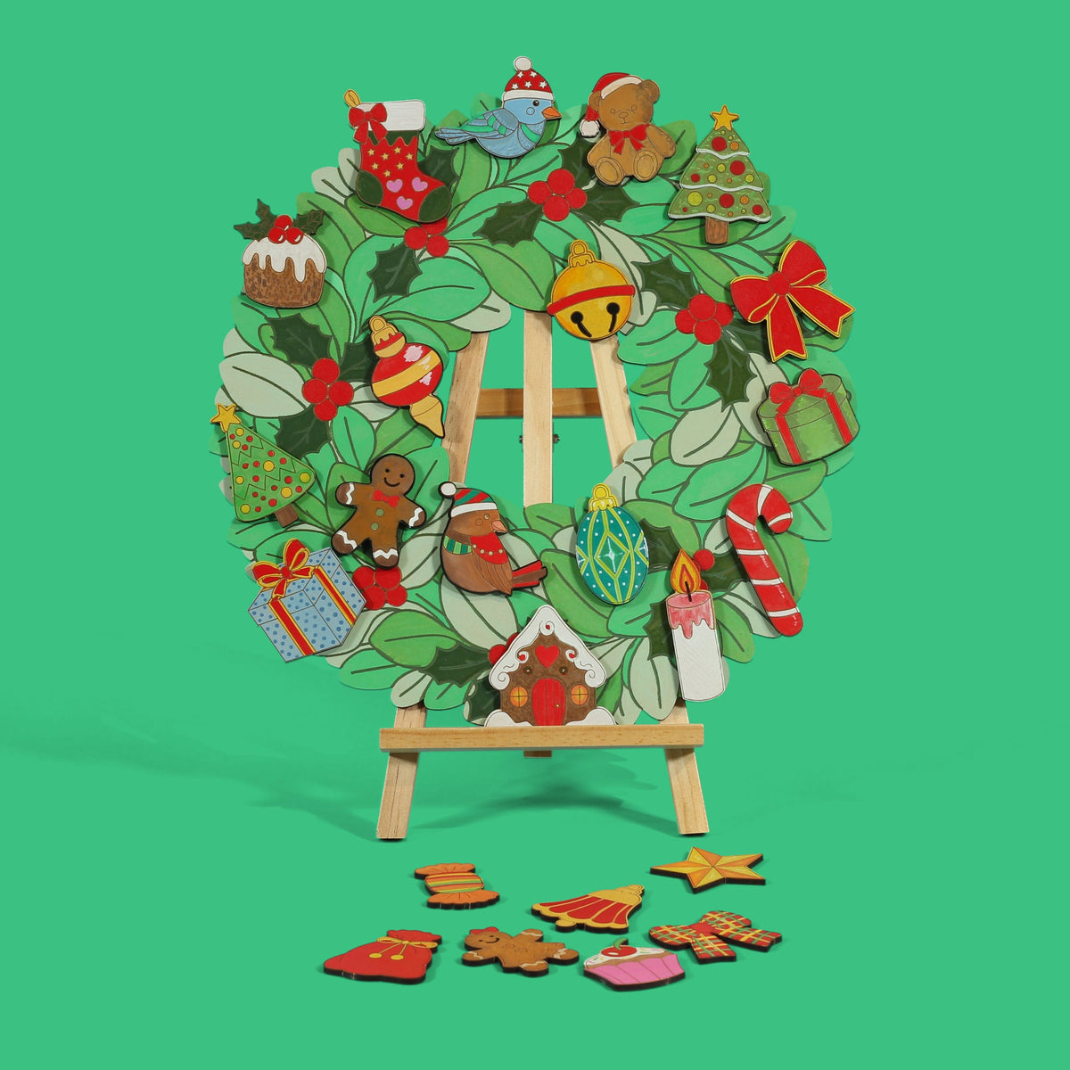 Jingle Jumble Christmas wreath coloured on easel with loose coloured engraved ornaments below on Apple Green background