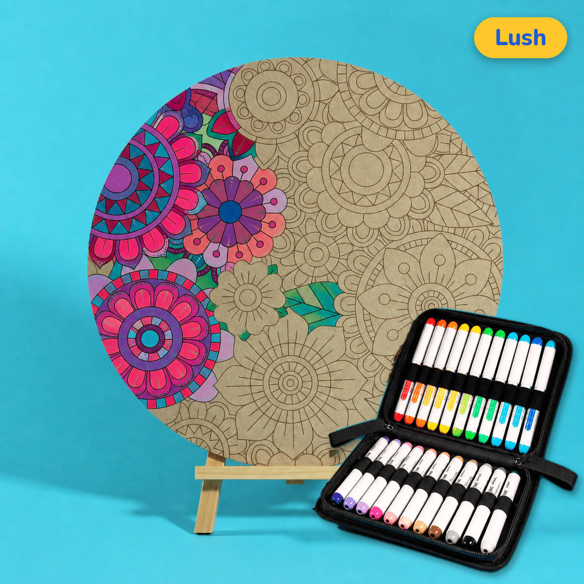 400mm Lush engraved circle art board with dense layered flowers and leaves, left edge coloured bright pink and purple, beside a case of 24 Nahuku markers
