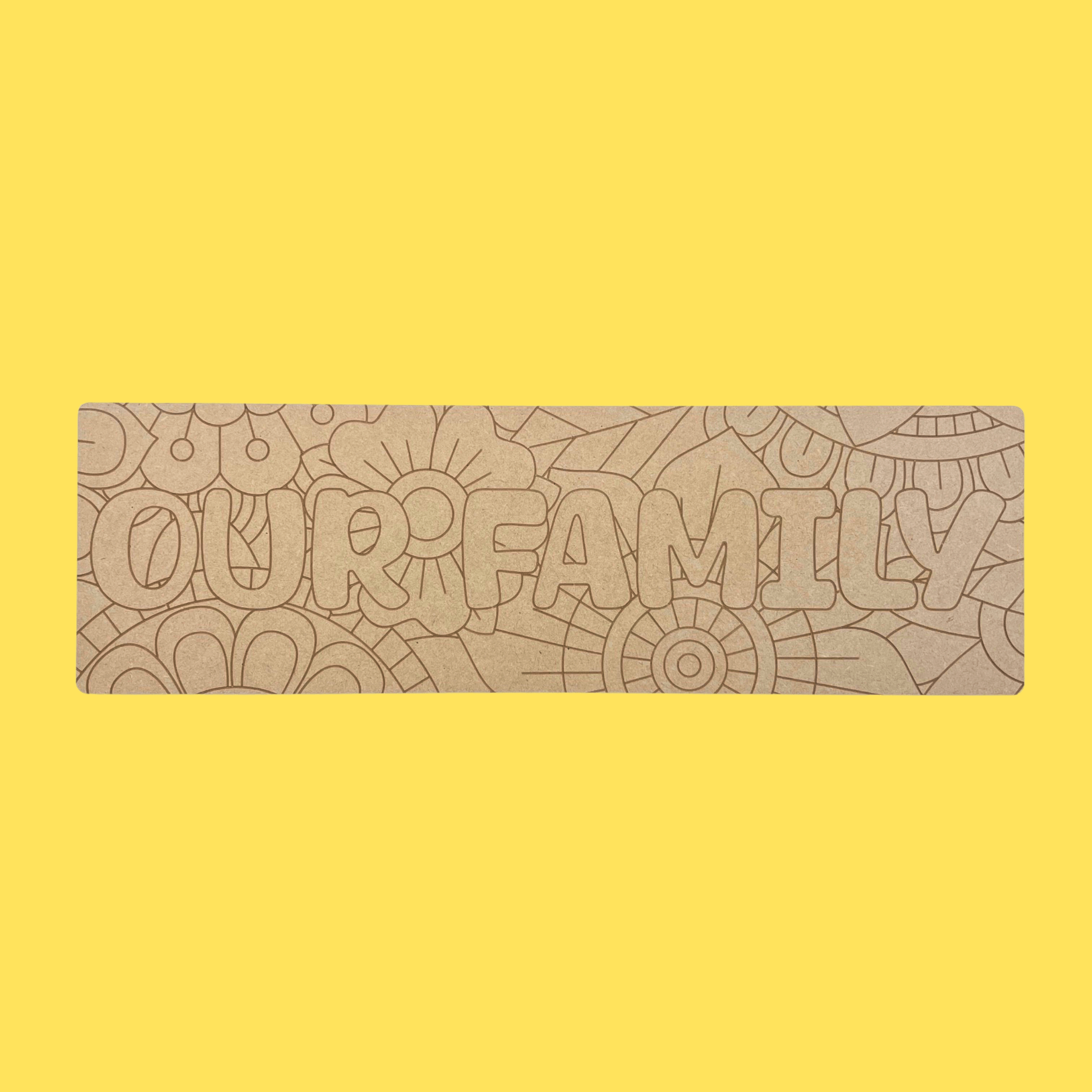 wooden board with engraved floral design and the words Our Family
