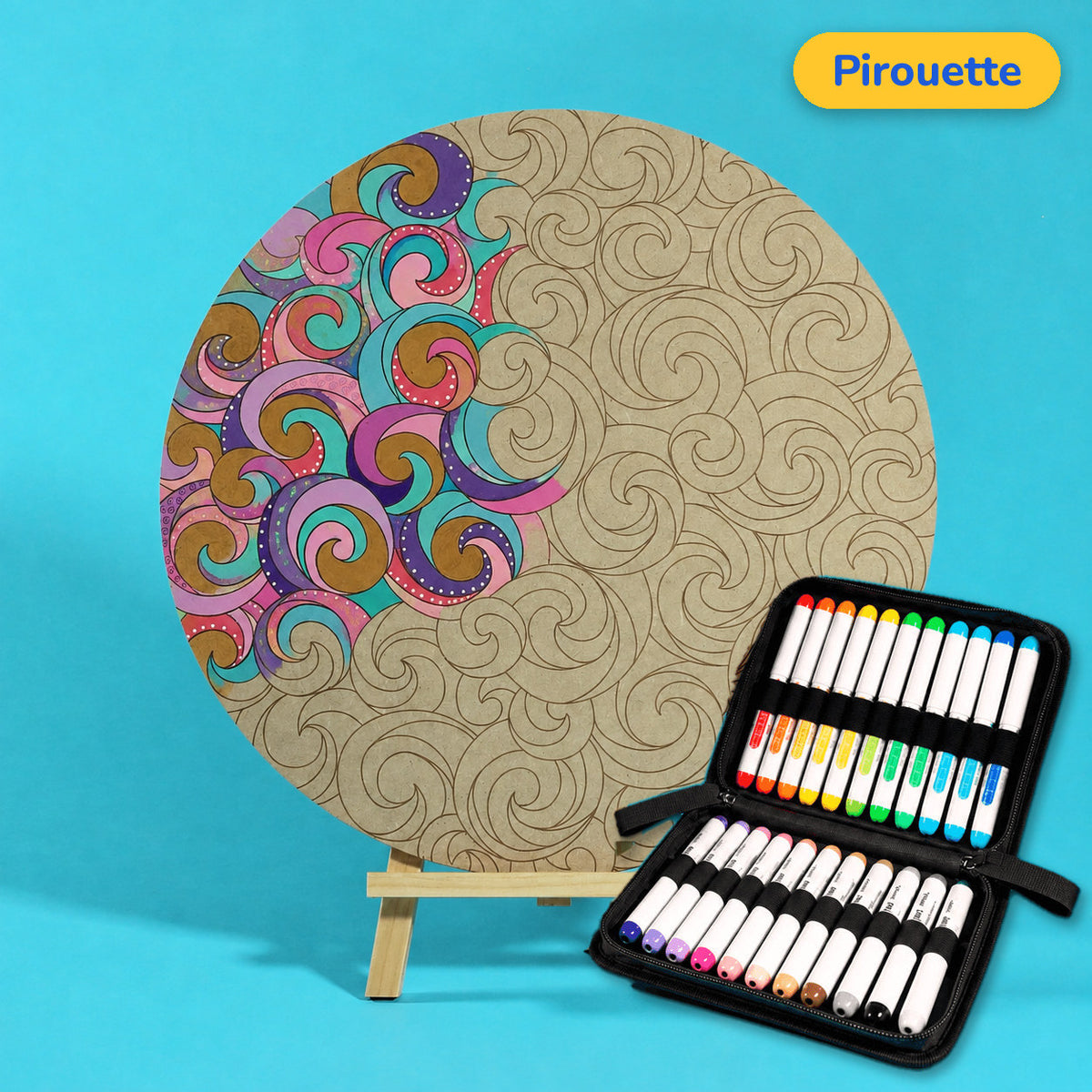 400mm Pirouette engraved circle art board with repeating curled swirls, left side coloured pink, teal and purple, beside a case of 24 Nahuku markers