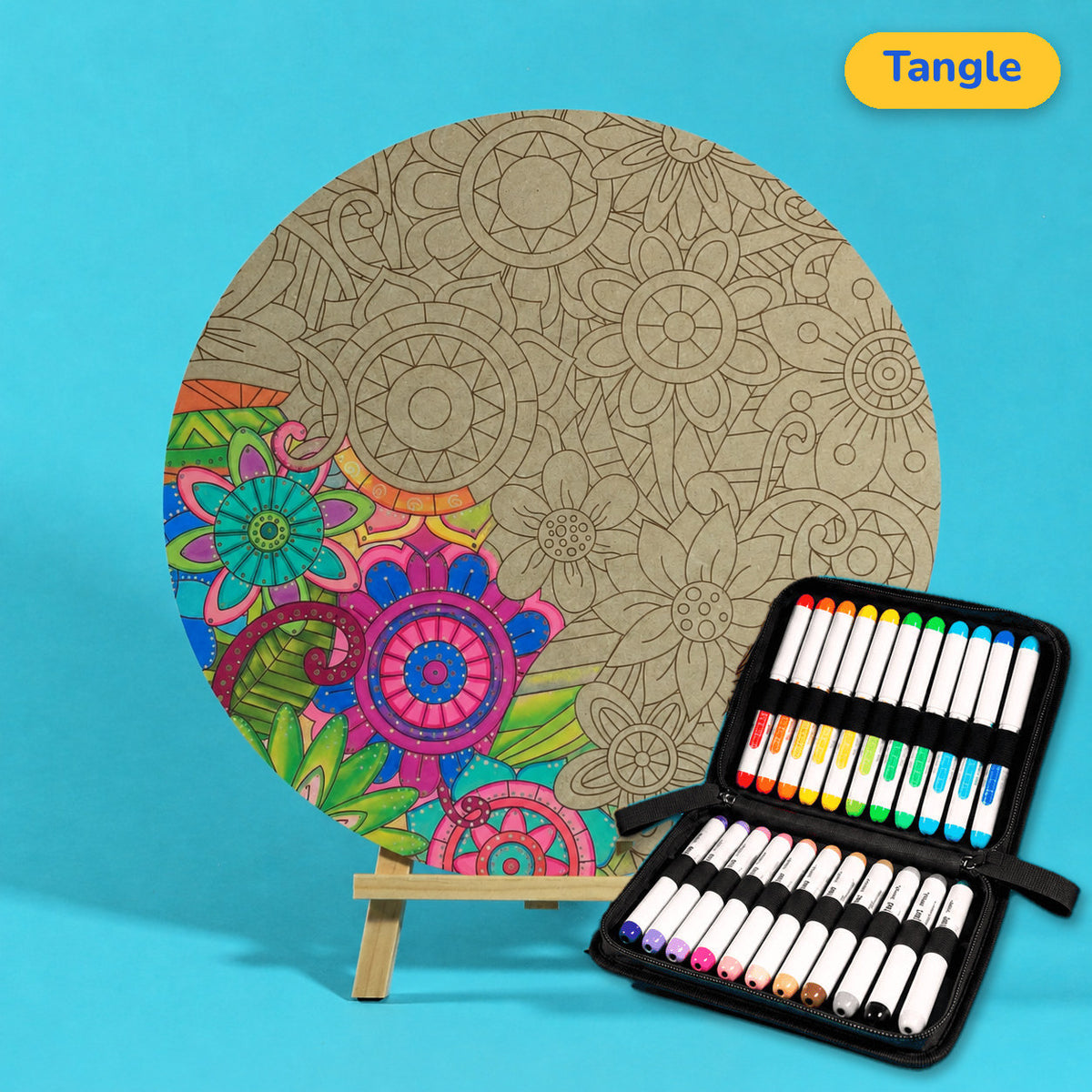 400mm Tangle engraved circle art board with looping flowers and leaves, lower left coloured pink, green and blue, beside a case of 24 Nahuku markers