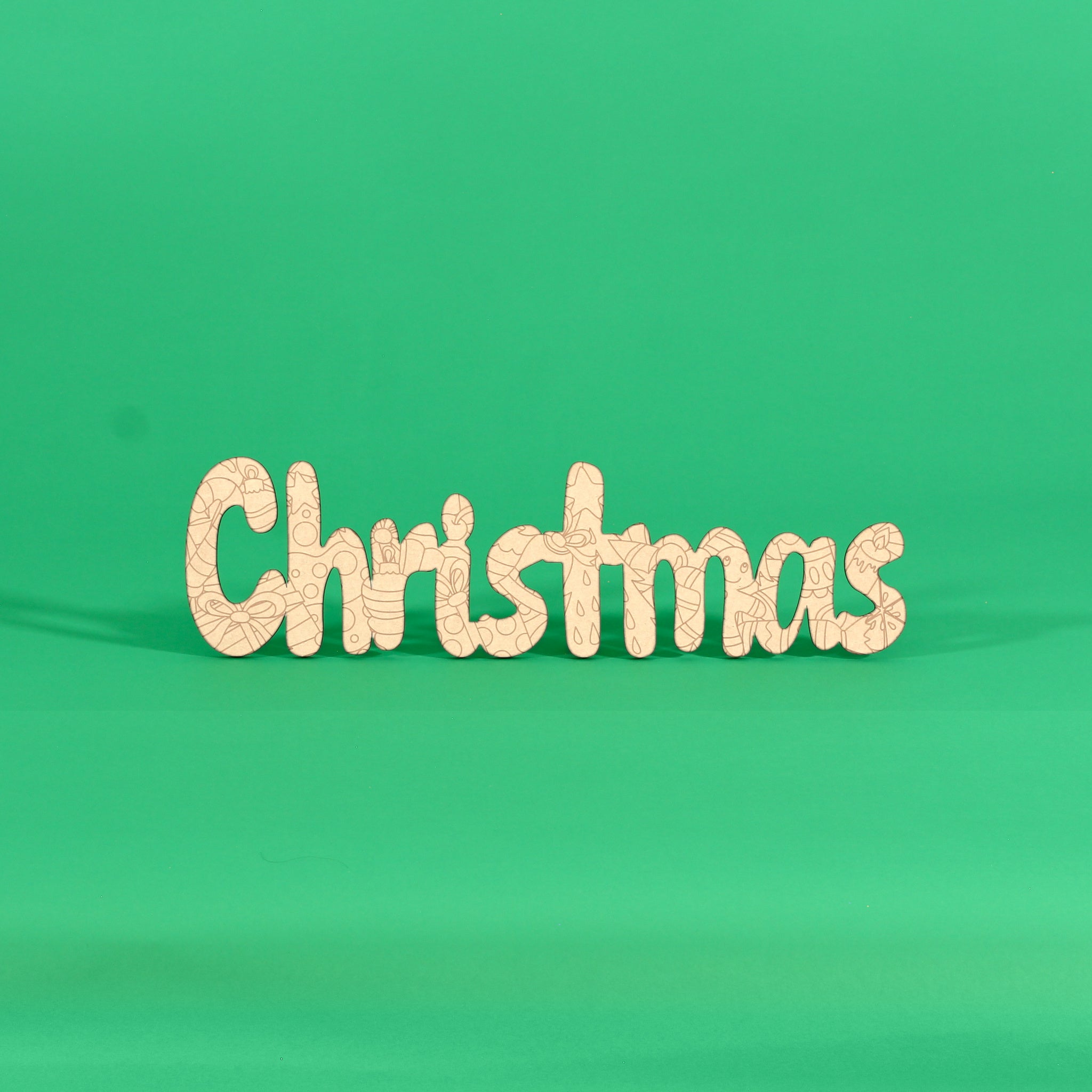 Colour your own ‘Christmas’ engraved word art board standing on a green background, Australian MDF Christmas sign with ornaments, holly, candy canes, stars and bows to colour
