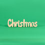 Colour your own ‘Christmas’ engraved word art board standing on a green background, Australian MDF Christmas sign with ornaments, holly, candy canes, stars and bows to colour