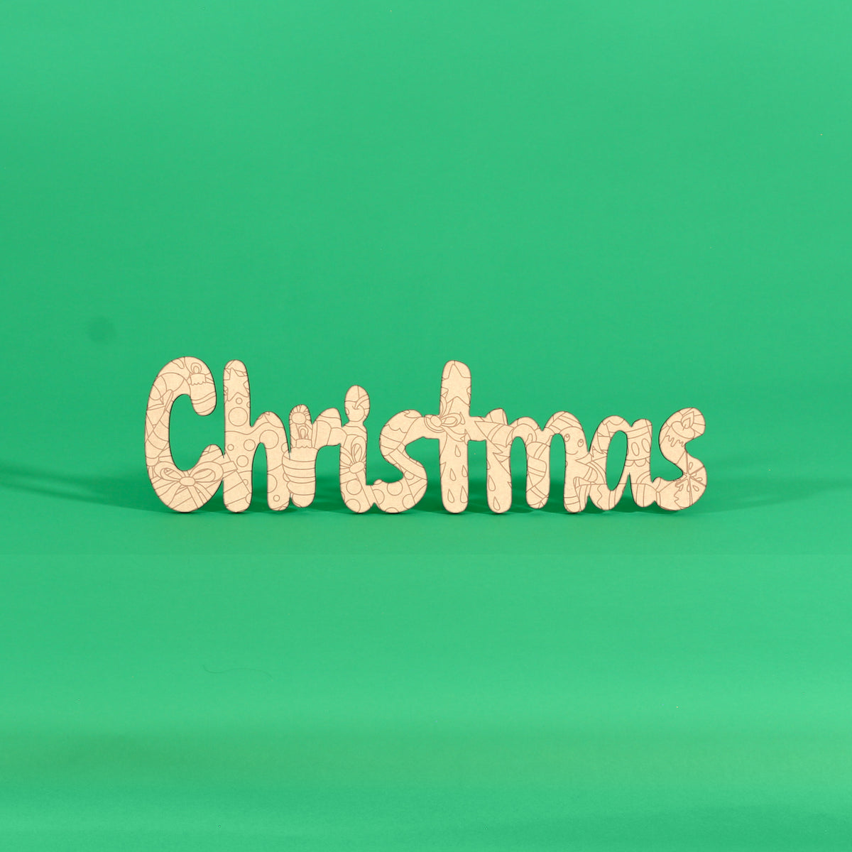 Colour your own ‘Christmas’ engraved word art board standing on a green background, Australian MDF Christmas sign with ornaments, holly, candy canes, stars and bows to colour