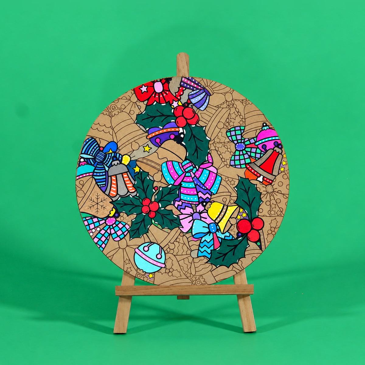 Holly Jolly Christmas engraved art board partly coloured with bells, bows and holly in pink, blue, red and green, easel not included