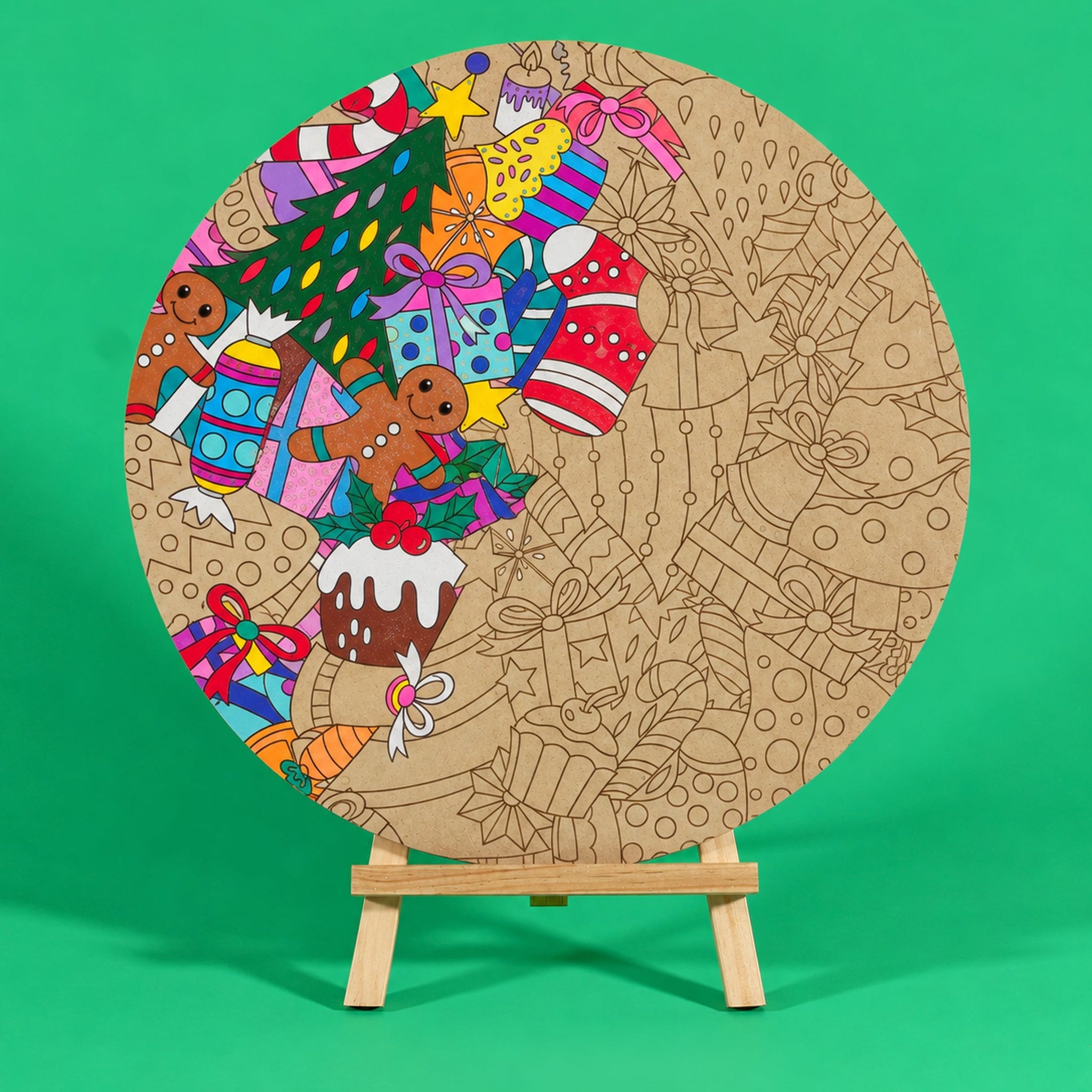 Jolly Tangle 400mm round Christmas art board on an easel, partly coloured, with gingerbread friends, presents, a Christmas tree, pudding and candy canes