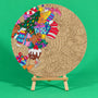 Jolly Tangle 400mm round Christmas art board on an easel, partly coloured, with gingerbread friends, presents, a Christmas tree, pudding and candy canes
