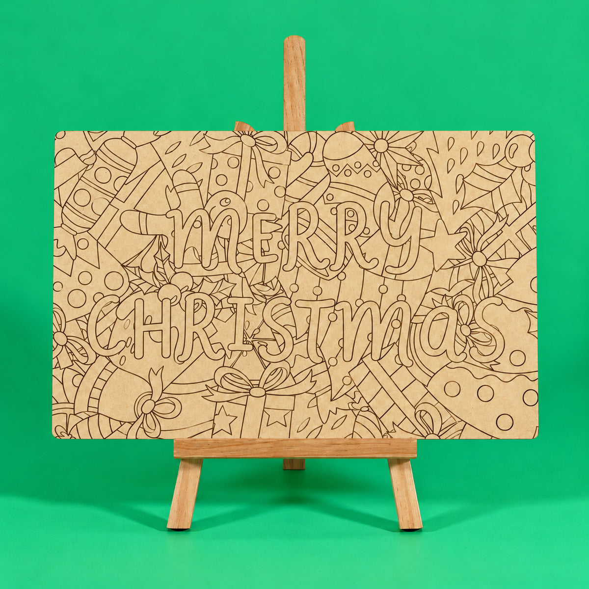 Merry Christmas engraved quote art board plain uncoloured engraved MDF board on easel ready to colour on green background