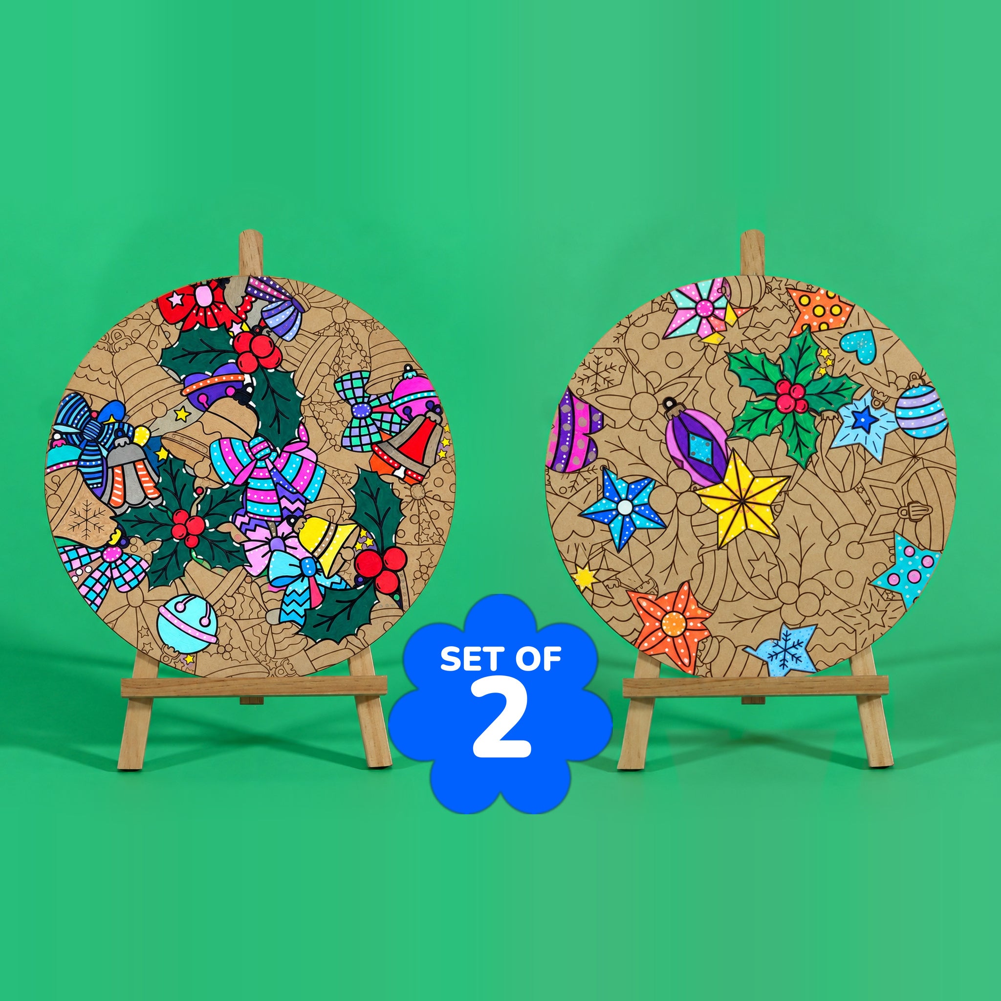 Merry Twinkle and Holly Jolly Christmas engraved art boards set of 2 partly coloured, Holly Jolly with bells and bows in pink, blue and red on the left, Merry Twinkle with yellow star and holly on the right, SET OF 2 badge, easels not included