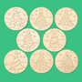 Christmas tree coasters to colour your own, scattered on green, a family Christmas craft for the table