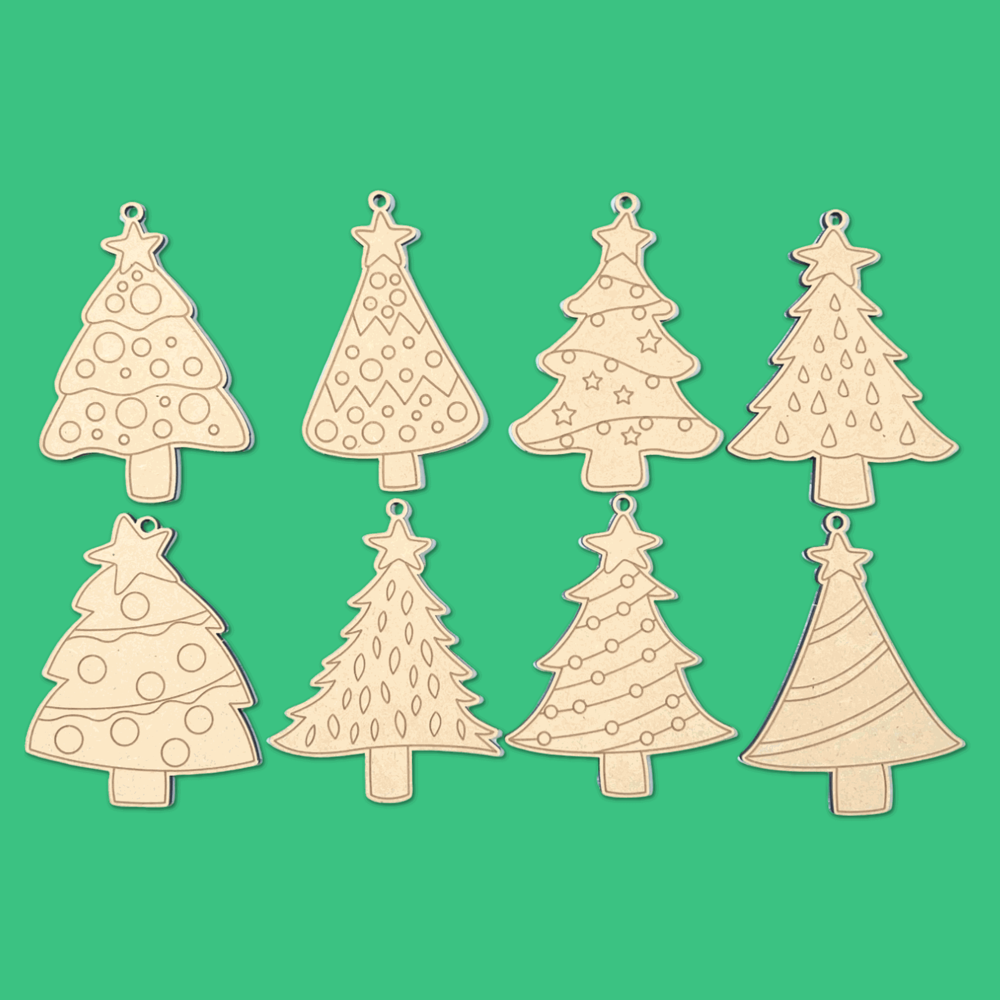 Eight Evergreen Magic paint your own Christmas tree ornaments laid out, star-topped tree designs in 4mm Australian MDF